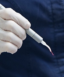 Dentist holding dental laser