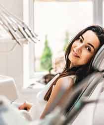 Smiling young woman in dental office