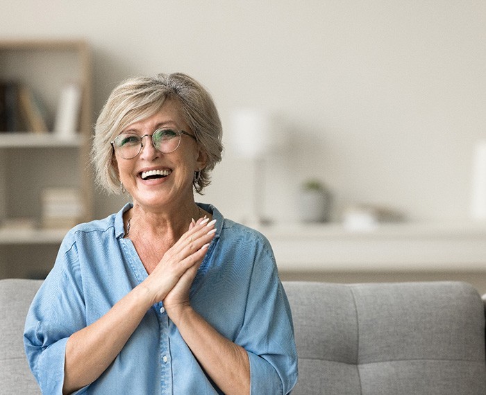 Senior woman clapping her hands and smiling