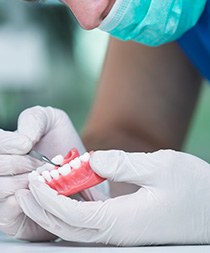 Technician placing artificial teeth in denture in Gilbert, AZ