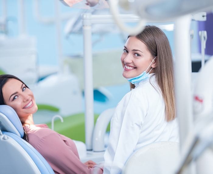 Dentist and patient smiling