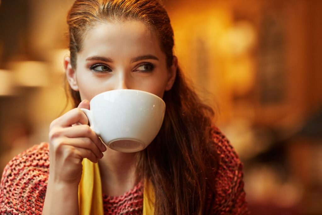 A woman drinking a cup of coffee